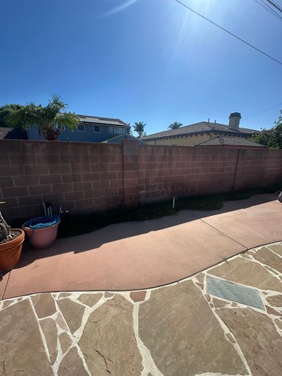 The same Downey backyard patio swept clean after the concrete was hauled away